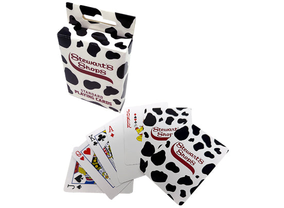 Playing cards with cow print design and 'Stewart's Shops' branding on a white background