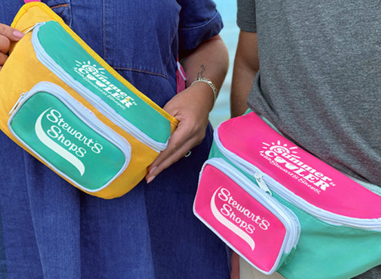 Two waist bags with Stewart's Shops branding, one yellow and green, the other pink and white.