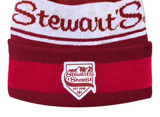 Red and white knit beanie with 'Stewart's Shops' logo on a white background