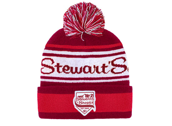 Red and white beanie with pom-pom and 'Stewart's' branding on a white background