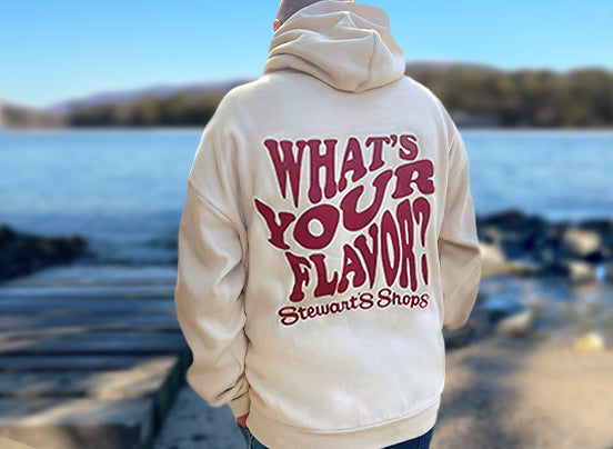 Oversized what's your flavor hoodie from the back. by a lake.