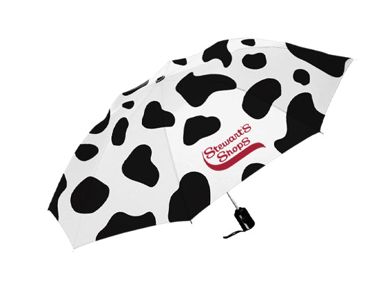 Umbrella with black and white cow print pattern and red logo on a white background