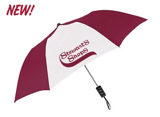 A maroon and white umbrella with alternating panels, featuring the Stewart’s Shops logo printed on a white panel. The umbrella has a black handle with a wrist strap.
