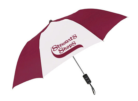 A maroon and white umbrella with alternating panels, featuring the Stewart’s Shops logo printed prominently on one of the white panels. The umbrella has a straight black handle with a wrist strap attached.