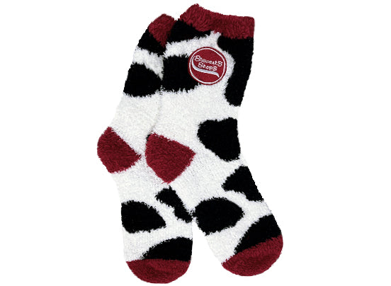 Fuzzy socks with cow print and the Stewart's Shops logo. The top, heal, and toes are maroon. 