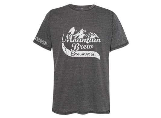 Dark gray short-sleeve t-shirt with a white graphic design on the front. The design features a mountain range above the words "Mountain Brew" in script font and "Stewart's" below in a ribbon style. 