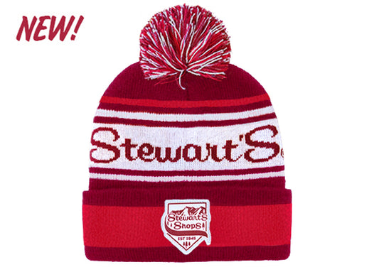 Red and white beanie with pom-pom and 'Stewart's' branding on a white background