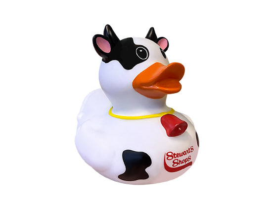 Cow-themed rubber duck with horns, black spots, an orange bill, and a red Stewart’s Shops logo on its chest.