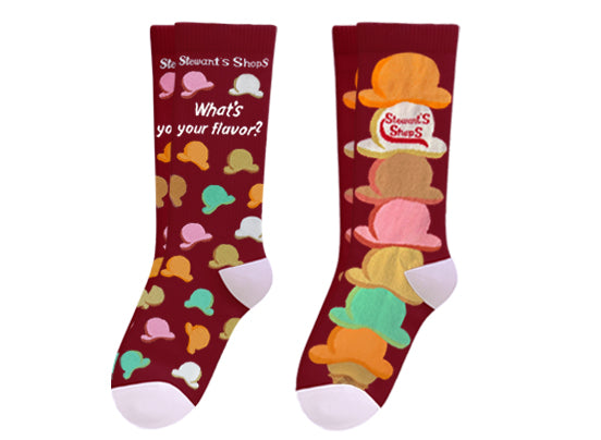 Two pairs of Stewart's Shops burgundy crew socks featuring colorful ice cream cone designs. One pair includes the phrase "What's your flavor?" with scattered scoops, while the other features stacked ice cream scoops with a Stewart's Shops logo.