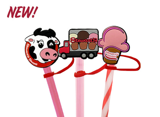 Three colorful straw toppers with cartoon cow, truck, and ice cream cone design on a white background.