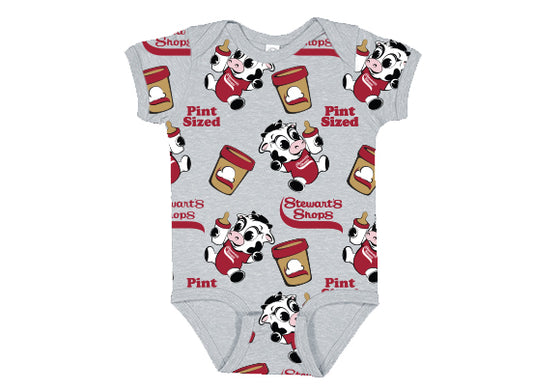 Gray baby onesie featuring an all-over print design with cartoon cow mascots, Stewart’s Shops ice cream pints, and the phrases “Pint Sized” and “Stewart’s Shops” in red text. The design is playful and colorful, with the cow holding an ice cream cone.